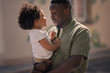 © Natalia - portrait of father holding daughter on the hands and talking