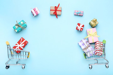 Poster - Small shopping carts with gift boxes on blue background