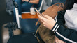 © Nuchylee - Close up hands of passenger traveler woman in airport waiting at departure lounge in airport using smart phone, lifestyle and travel concept