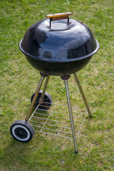 Charcoal barbecue grill, mobile brazier, burning wood, closed the lid