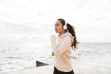 Wall Mural - Attractive young asian fitness woman jogging