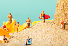 Miniature People In Swimsuit On The Beach