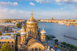Aerial view of the domes of the Assumption Church on the embankment of the Neva River, in the distance Isaaic Cathedral.