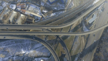 Wall Mural - Aerial shot of a little heavy urban traffic on the highway near the forest. Public transport is moving easily.
