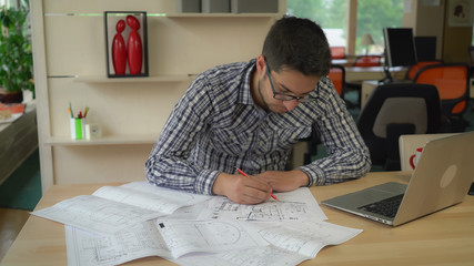 Aufkleber - mixed race man holding pencil and line sitting at the working place drawing