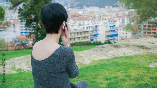 City View On The Buildings In Summer Day Female Calling On