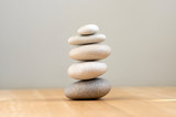 Fototapeta Desenie - Harmony and balance, cairns, simple poise pebbles on wooden light white gray background, simplicity rock zen sculpture
