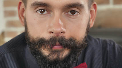 Poster - closeup portrait young man with beard and mustache looking at the camera with happy friendly cheerful smile