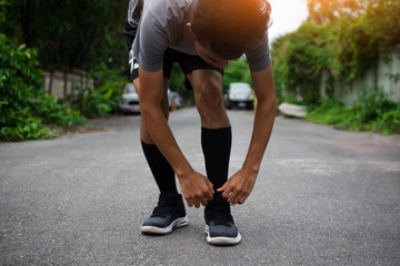 Wall Mural - Runners tied in shoes,Man run on the street be running for exercise,Run sports background and closeup at running shoe