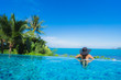 © siraphol - Portrait beautiful young asian woman relax in luxury outdoor swimming pool in hotel resort nearly beach sea ocean