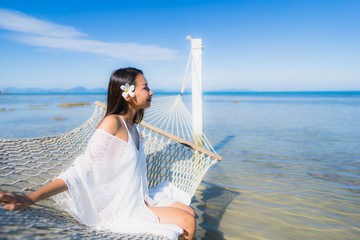 Portrait beautiful young asian woman sitting on hammock around sea beach ocean for relax