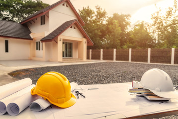 Architect desk with blueprint and hard hat constuction building.