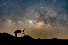 Silhouette Of Man Watching Star In Telescope Against  Milky Way Galaxy With Stars And Space Dust In The Universe.