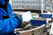 © kokliang1981 - Closeup shooting hand of worker with clipboard checking plastic crate for fruits and vegetables loading on conveyor machine in cold room warehouse, Import and export management system to customer.