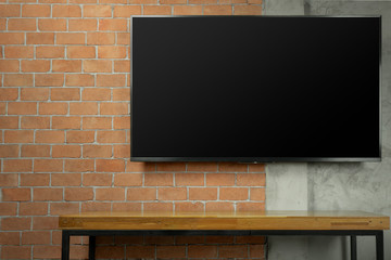 Wall Mural - blank screen Led Tv on red brick wall with media wooden table