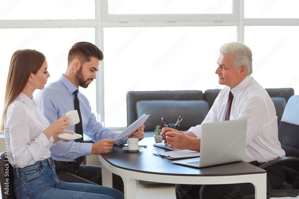 Couple meeting with notary public in office
