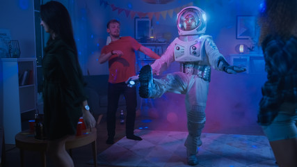 at the college house costume party: fun guy wearing space suit dances off, doing robot dance modern 
