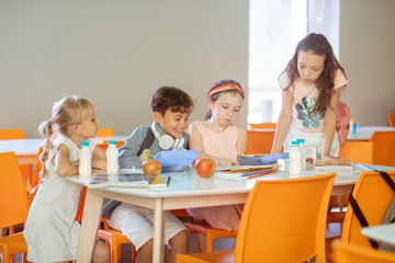 Children feeling busy while learning poem and eating lunch