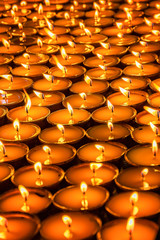 Tibetan buddhist butter lamps arranged together in a temple for worship