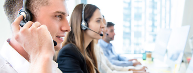 Wall Mural - Male operator staff with team working call center