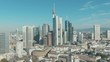 Aerial Drone Shot view of the famous Skyline of Frankfurt am Main with many Skyscrapers and huge buildings from banks on a sunny day with blue sky in Mainhattan