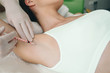 woman receives an underarm treatment, hyperhidrosis. Armpit injections to prevent excessive sweating