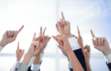 group of young entrepreneurs pointing up to a copy of the space