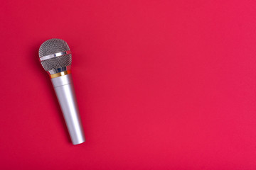 Concert microphone on a beautiful red background.