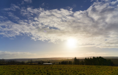 Wall Mural - blue sky and sun rising over blanchland common moors in the north of england.