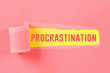 Procrastination, delay, urgency concept. Torn off piece paper opening inscription procrastination.