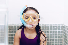 Little Girl With Snorkel Goggles In The Tub