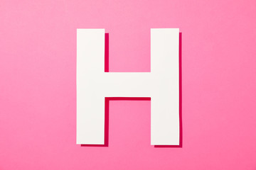 White letter H on color background, space for text