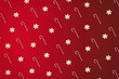 Christmas cane and snowflakes pattern top view on the red holiday background. Sweet wrapping design