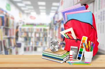 Sticker - Colorful school supplies in backpack on white background