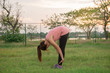 © reewungjunerr - Asian woman sit for stretching body on the lawn in the evening,Thailand people exercise at the park
