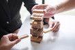Alternative Risk and Strategy in Business, Hand of business team cooperative gambling placing making wooden block hierarchy on the tower to collaborative planning and development to successful