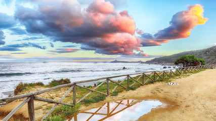 Wall Mural - Fantastic view of Capo Carbonara beach with turquoise water and fence