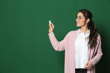 Poster - Portrait of beautiful young teacher near chalkboard, space for text