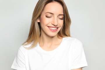 Sticker - Portrait of young woman with beautiful face on grey background