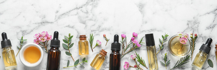 Poster - Flat lay composition with bottles of natural tea tree oil and space for text on white marble background