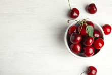 Bowl With Sweet Cherries On White Wooden Table, Top View. Space For Text