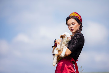 Glamour caucasian Model in Russian Style Kokoshnik Posing With Newborn Lamb Cub Against Nature Background.