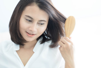 Wall Mural - Woman looking reflection in the mirror serious hair loss problem for health care shampoo and beauty product concept