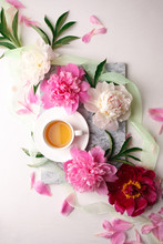 Creative Layout With Pink White Peonies Flowers And Cup Of Tea On Bright Table. Spring Seasonal Valentine, Woman, Mother, 8 March Holiday, Romance Breakfast