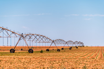 Brownfield, USA Texas rural countryside industrial field with water or fertilizer chemicals sprayer on dry land