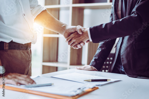 Cuadros en Lienzo Middle age Asian partner lawyers attorneys shaking hands after discussing a contract agreement done