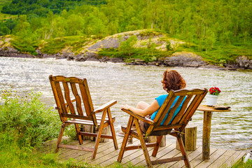 Canvas Print - Woman relaxing on norwegian fjord shore