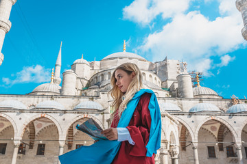 Wall Mural - Beautiful girl looks at Turkey map.