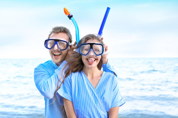 Sticker - Happy young couple with snorkeling masks at sea resort