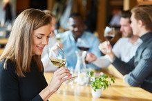 Woman Is Drinking A Glass Of Wine On A Wine Tasting